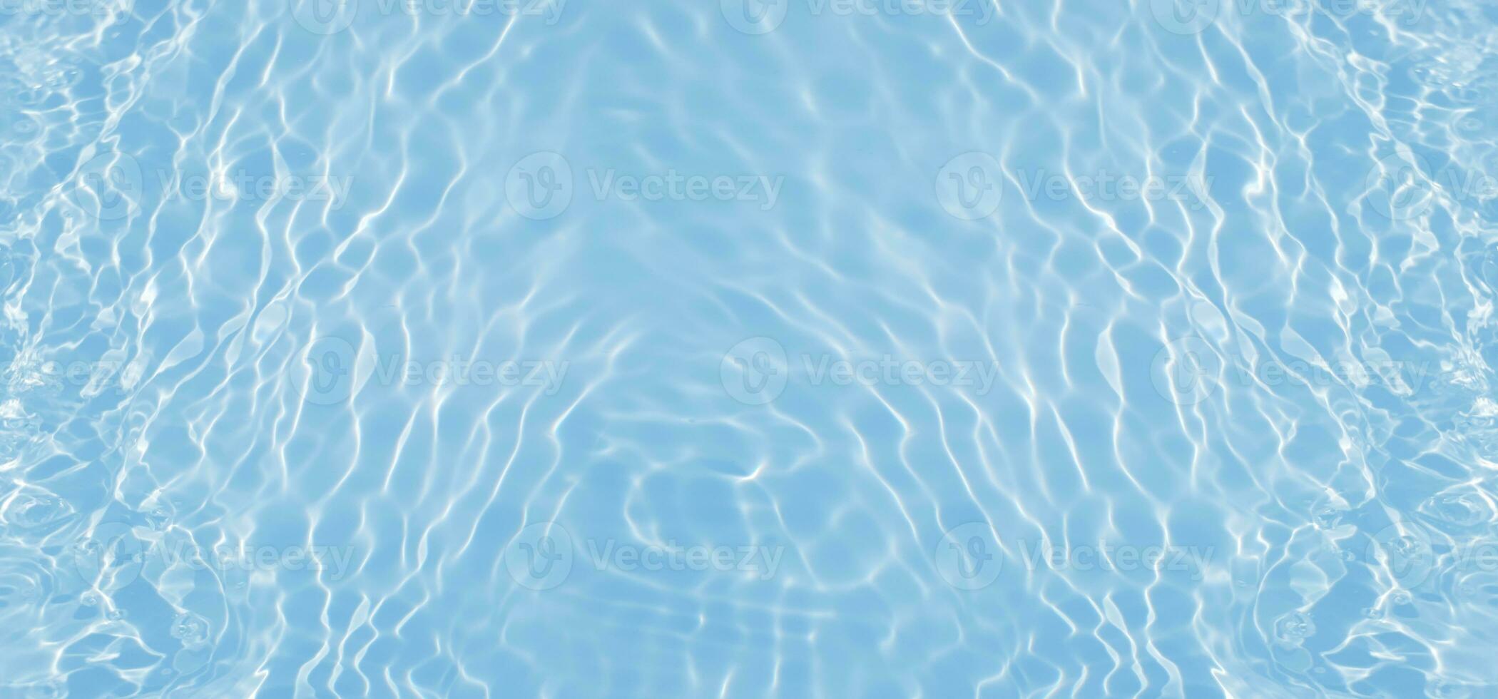 Blue water with ripples on the surface. Defocus blurred transparent blue colored clear calm water surface texture with splashes and bubbles. Water waves with shining pattern texture background. photo