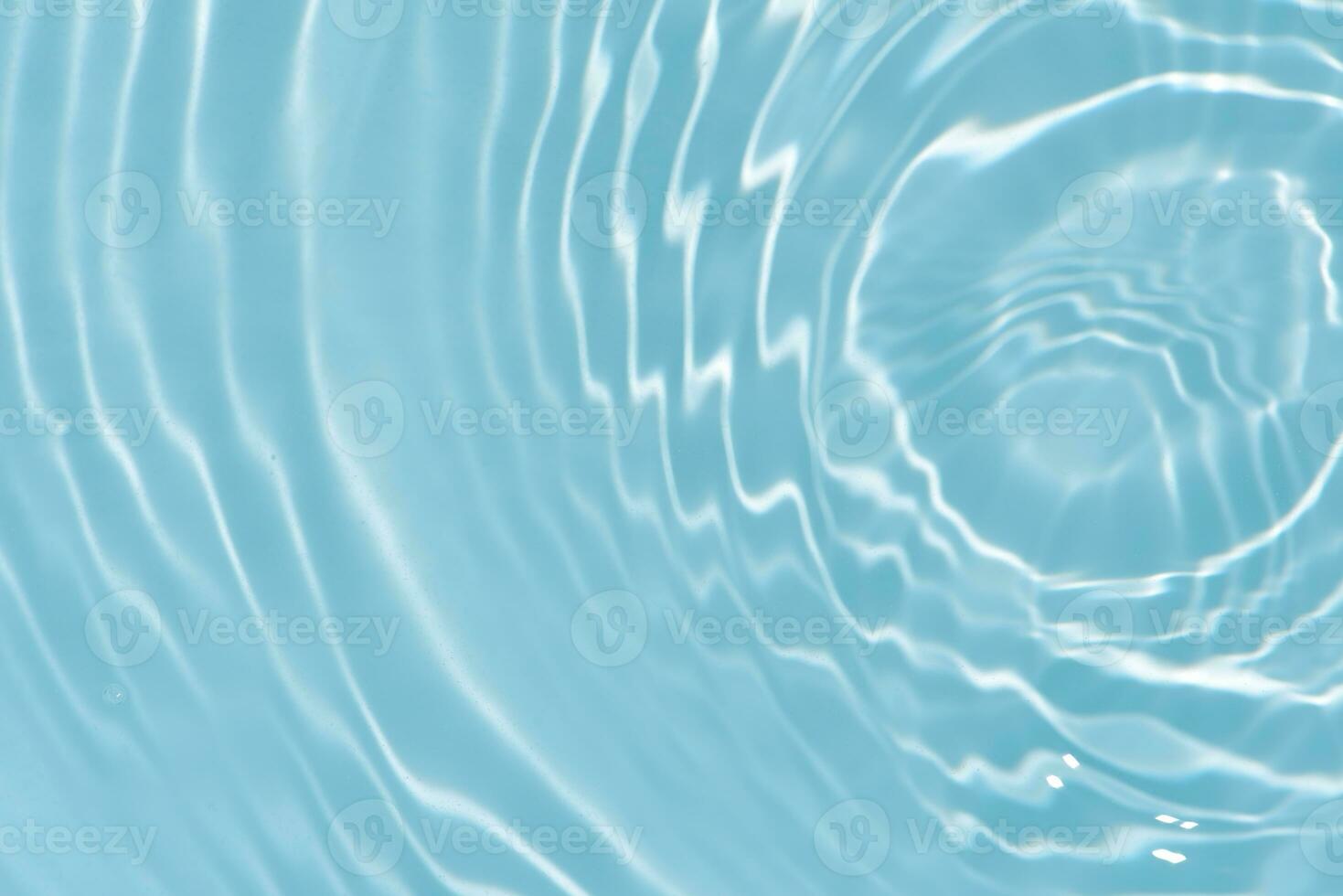 Blue water with ripples on the surface. Defocus blurred transparent blue colored clear calm water surface texture with splashes and bubbles. Water waves with shining pattern texture background. photo