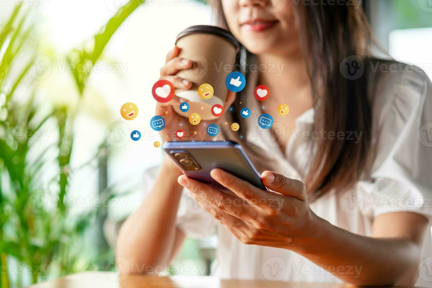 Young woman with drinks using mobile phone and relaxing in cafe, Modern lifestyle and social media concept photo