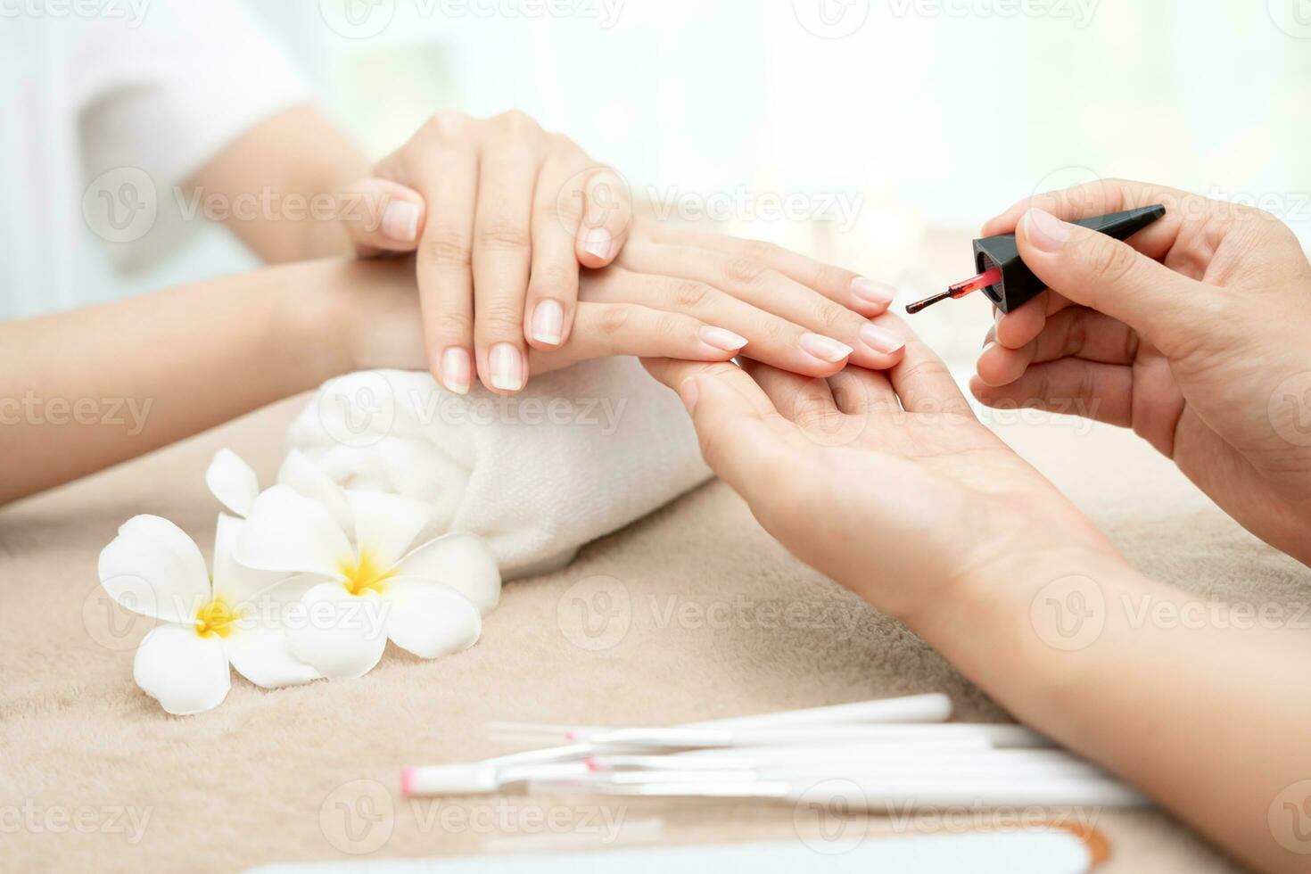 Woman receive care service by professional Beautician Manicure at spa centre. Nail beauty salon use nail file for Glazing treatment. manicurist make nail customer to beautiful. body care spa treatment photo