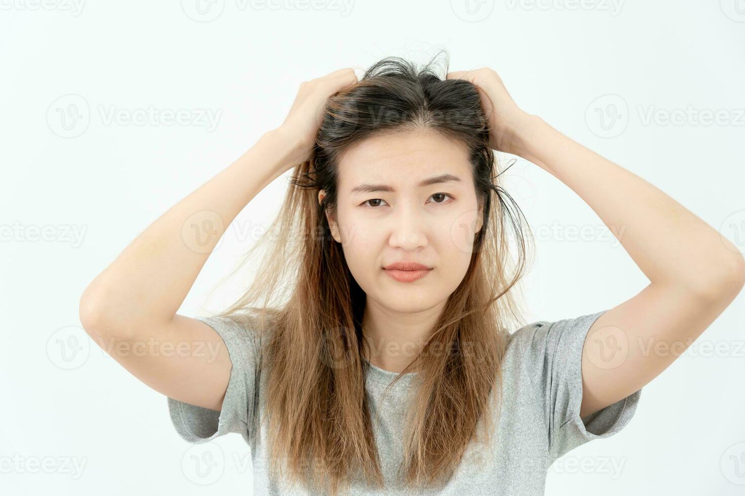 Asian woman very sad and upset looking at damaged hair, hair loss, hair thinning problem, vitamin deficiency, baldness, postpartum, biotin, zinc, menstrual or endocrine disorders, hormonal imbalance photo
