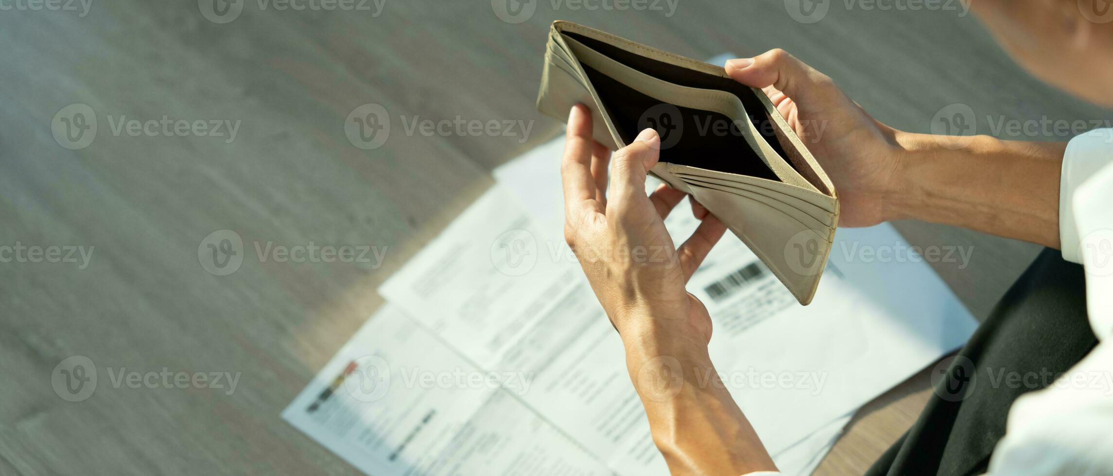 Stressed and headache man with large bills or invoices no money to pay to expenses and credit card debt. shortage, Financial problem, bankruptcy, mortgage, loan, bankrupt, poor, empty wallet photo
