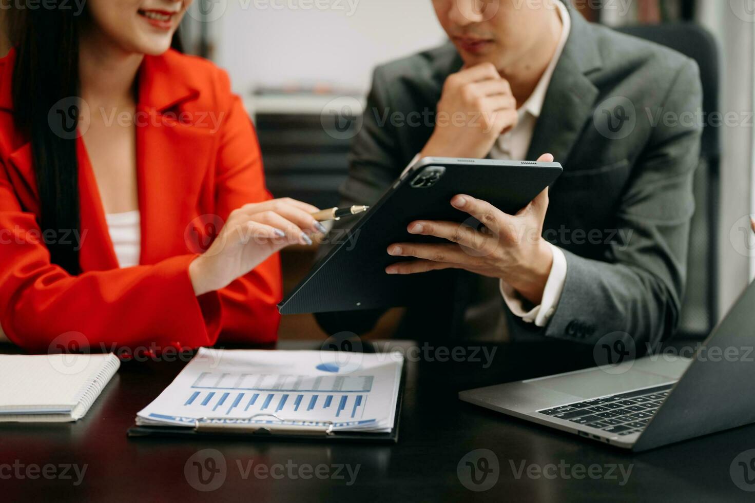 Business partners discussing documents and ideas with smart phone and digital tablet and graph business at meeting working new start up project. Finance task. photo