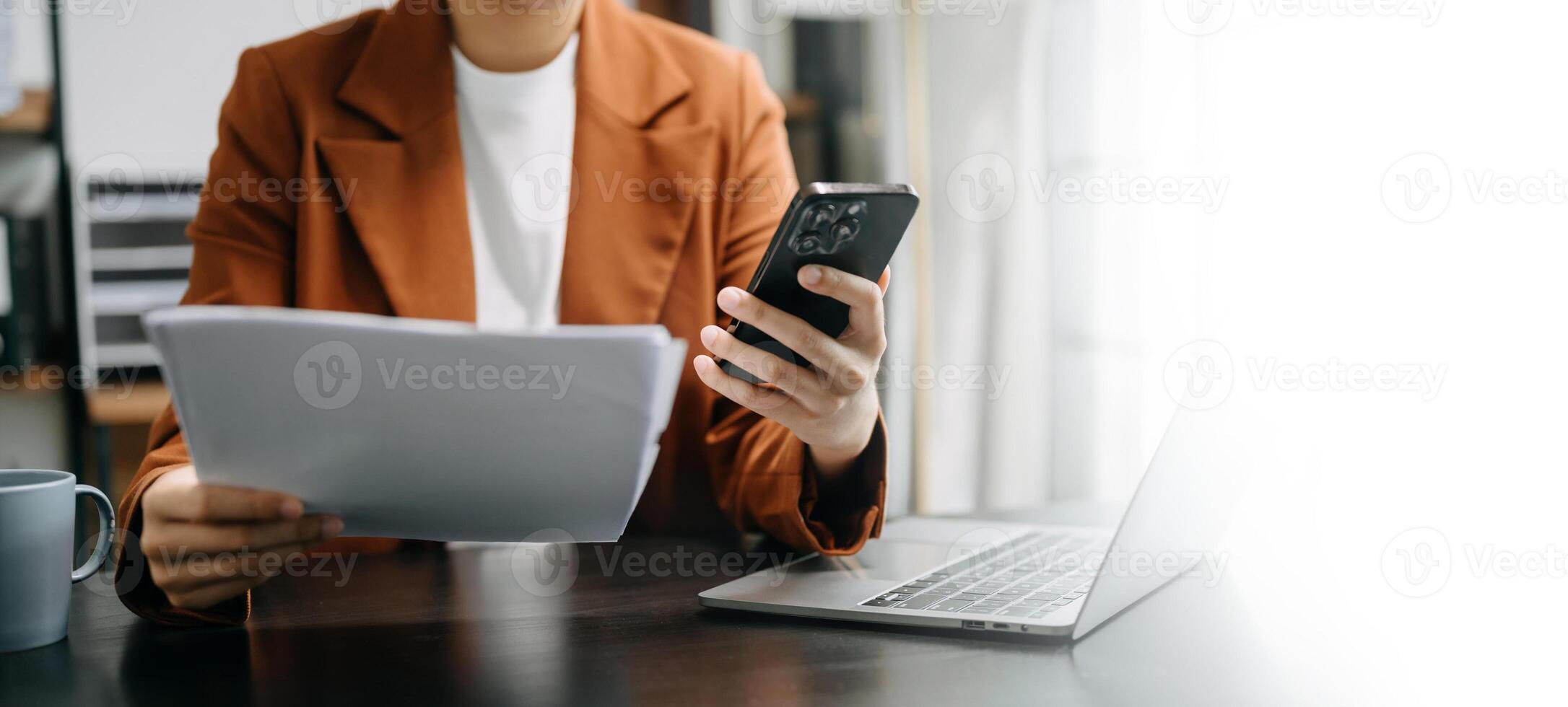 Business woman sitting front tablet ,laptop computer with financial graphs and statistics on monitor.at office photo
