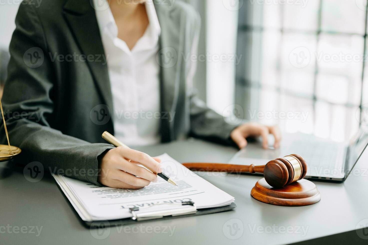 justice and law concept. Male judge in a courtroom the gavel, working with smart phone and laptop and digital tablet computer on table photo