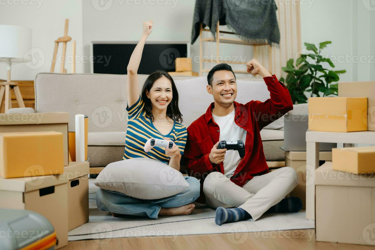Asian young attractive couple man and woman use tablet and smartphone online shopping furniture decorate house with carton package move in new house. photo