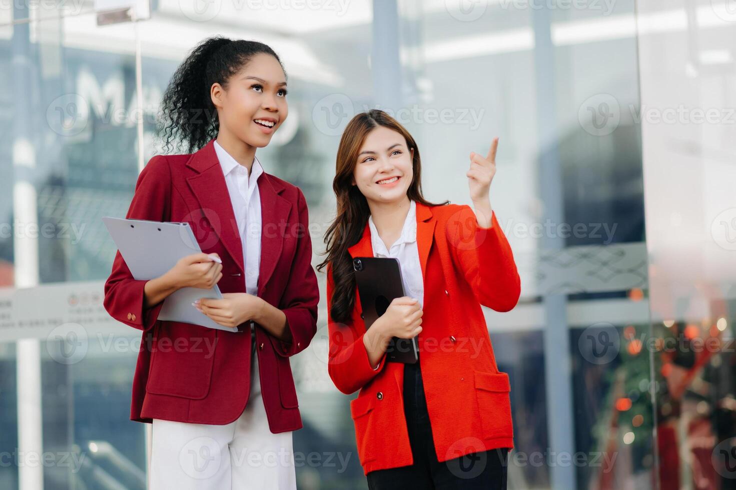 Two businesswoman discuss investment project working and planning strategy with tablet laptop computer in modern office. photo