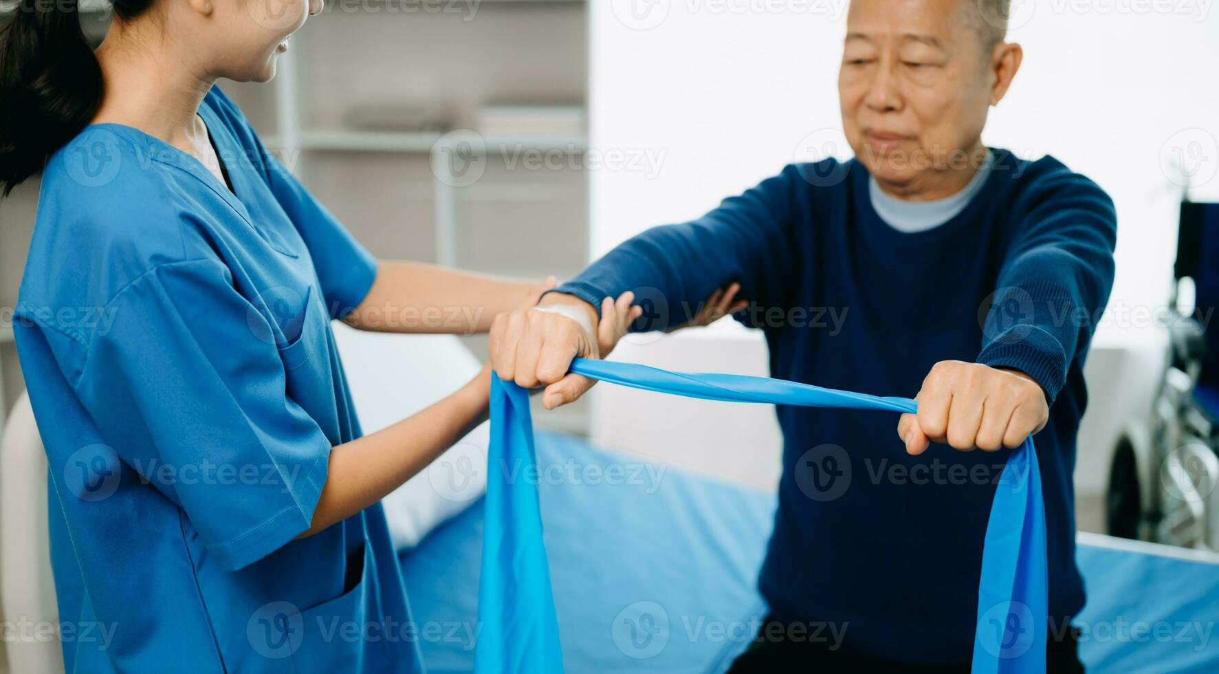 Physiotherapist Helping Patient While Stretching His Leg in bed in clinic photo