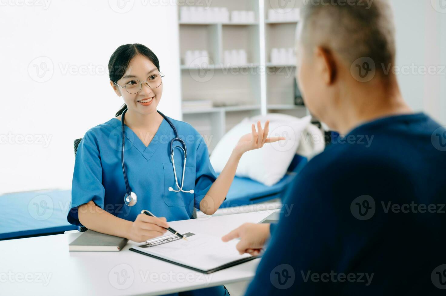 Serious Asia female doctor using clipboard is delivering great news talk discuss results or symptoms with female patient in clinic or hospital photo