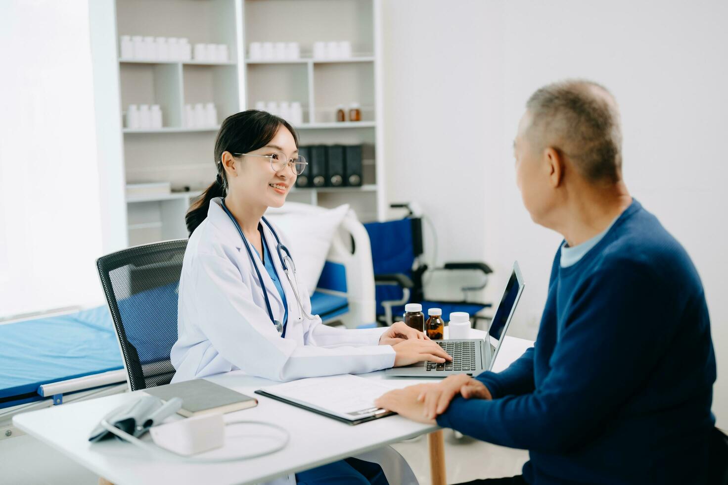 Serious Asia female doctor using clipboard is delivering great news talk discuss results or symptoms with female patient in clinic or hospital photo