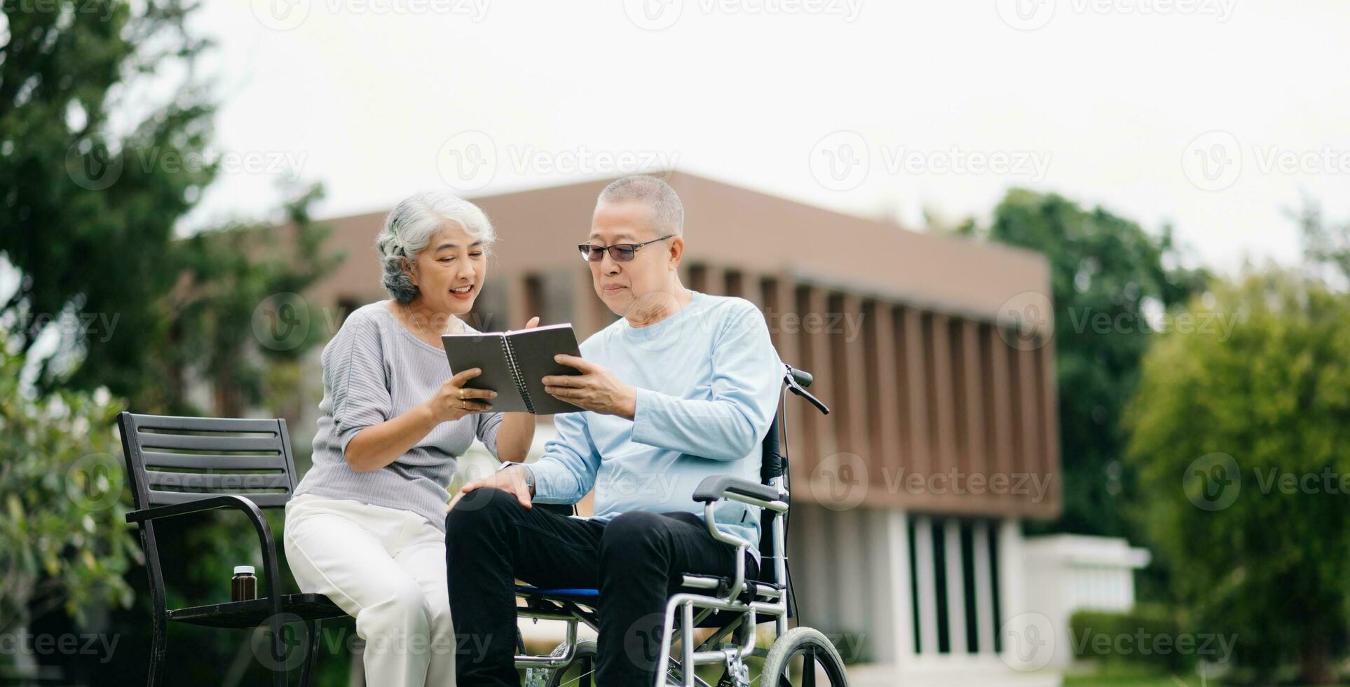 Asian senior couple having a good time. They laughing and smiling while sitting outdoor at the park. Lovely senior couple photo