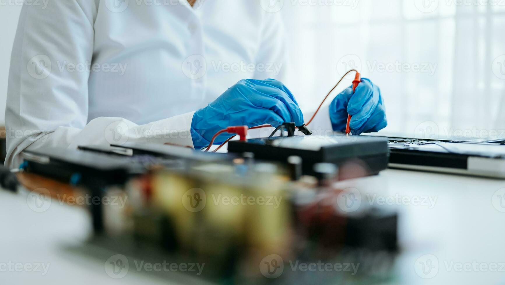 Electronics technician, electronic engineering electronic repair,electronics measuring and testing, repair and maintenance concepts.uses a voltage meter to check and upgrade photo