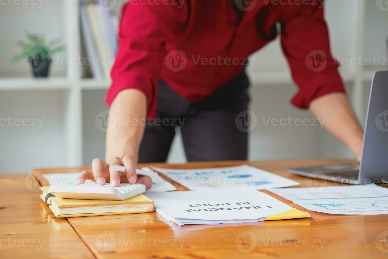 Business accounting concept, A businessman using a calculator with a computer laptop, budget, and loan paper in the office. photo