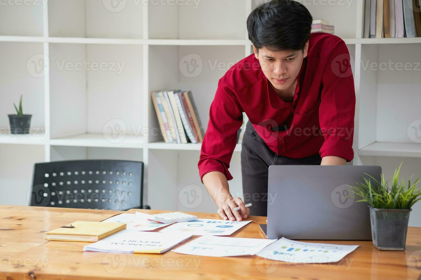 Business accounting concept, A businessman using a calculator with a computer laptop, budget, and loan paper in the office. photo