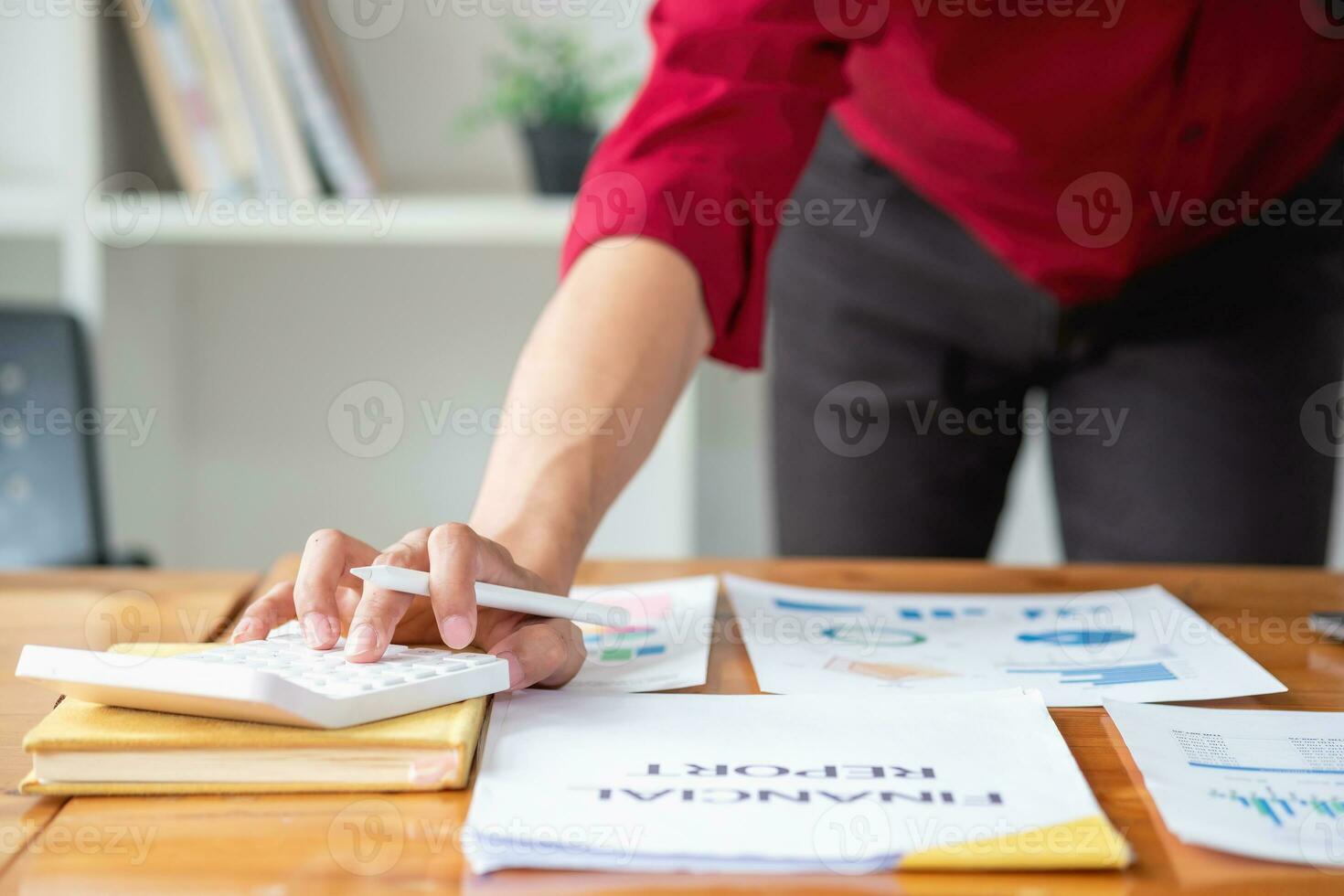Business accounting concept, A businessman using a calculator with a computer laptop, budget, and loan paper in the office. photo