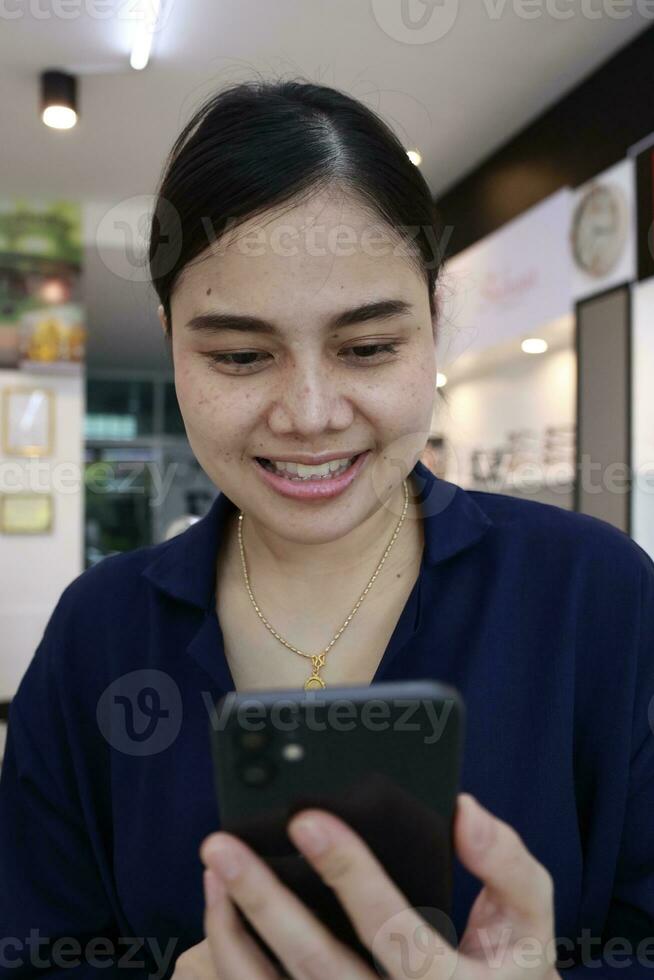 Person using phone, woman using mobile phone at home photo