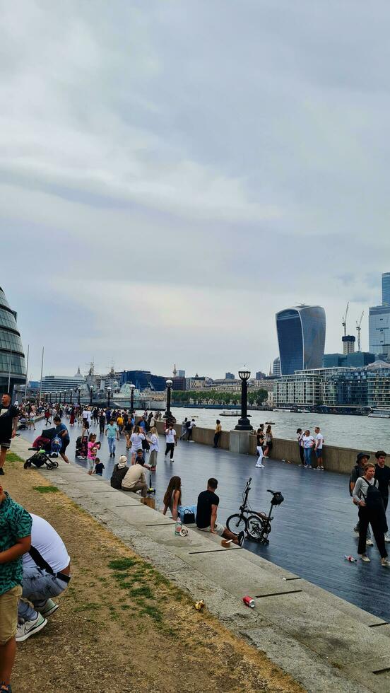 Low Angle View of World Famous Tourist Attraction at Tower Bridge and River Thames Which is Mostly Crowded with International Tourists at Central London, England UK. Captured on June, 18th 2023 photo