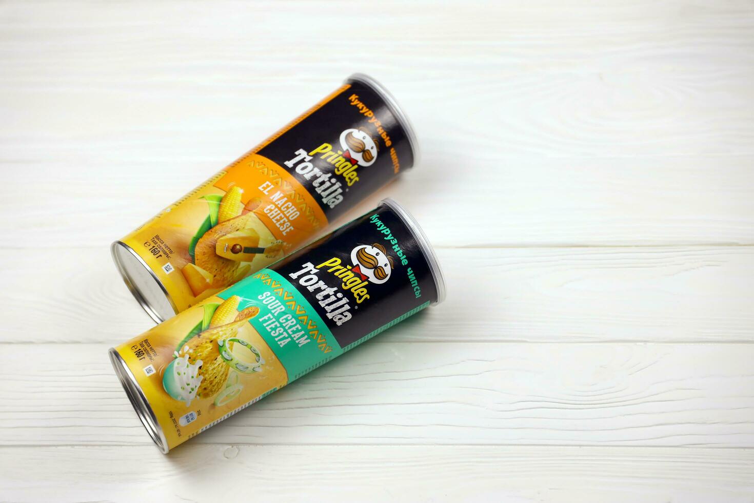 Pringles cylinder tubes with Tortilla el nacho cheese and sour cream fiesta flavour. Pringles is a brand of potato snack chips owned by Kellogg Company photo
