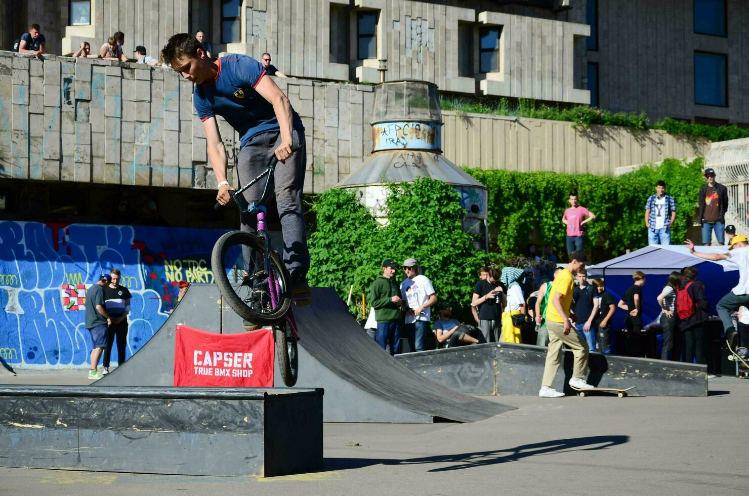 KHARKIV, UKRAINE - 27 MAY, 2018 Freestyle BMX riders in a skatepark during the annual festival of street cultures photo