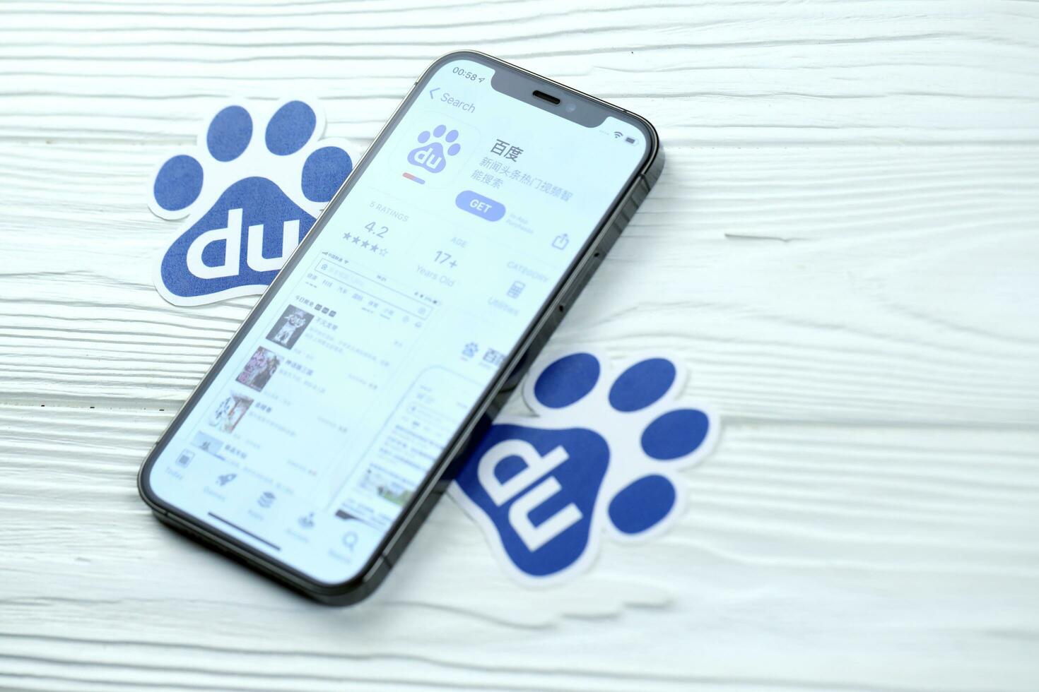 KHARKOV, UKRAINE - MARCH 5, 2021 Baidu icon and application from App store on iPhone 12 pro display screen on white table photo