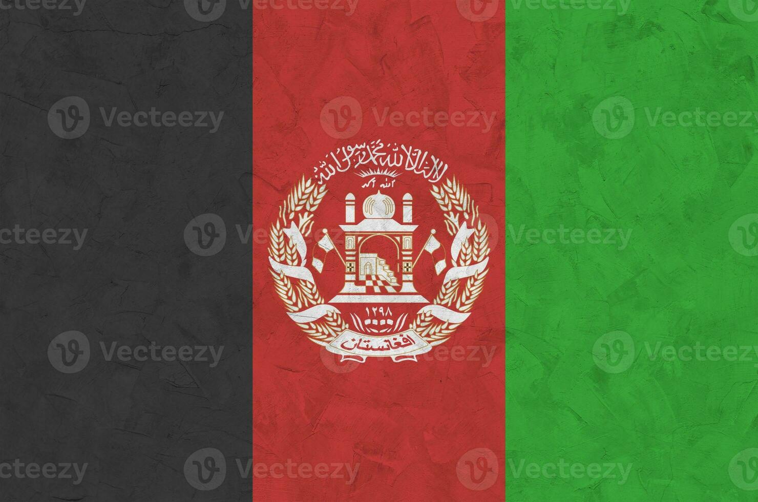 Afghanistan flag depicted in bright paint colors on old relief plastering wall. Textured banner on rough background photo