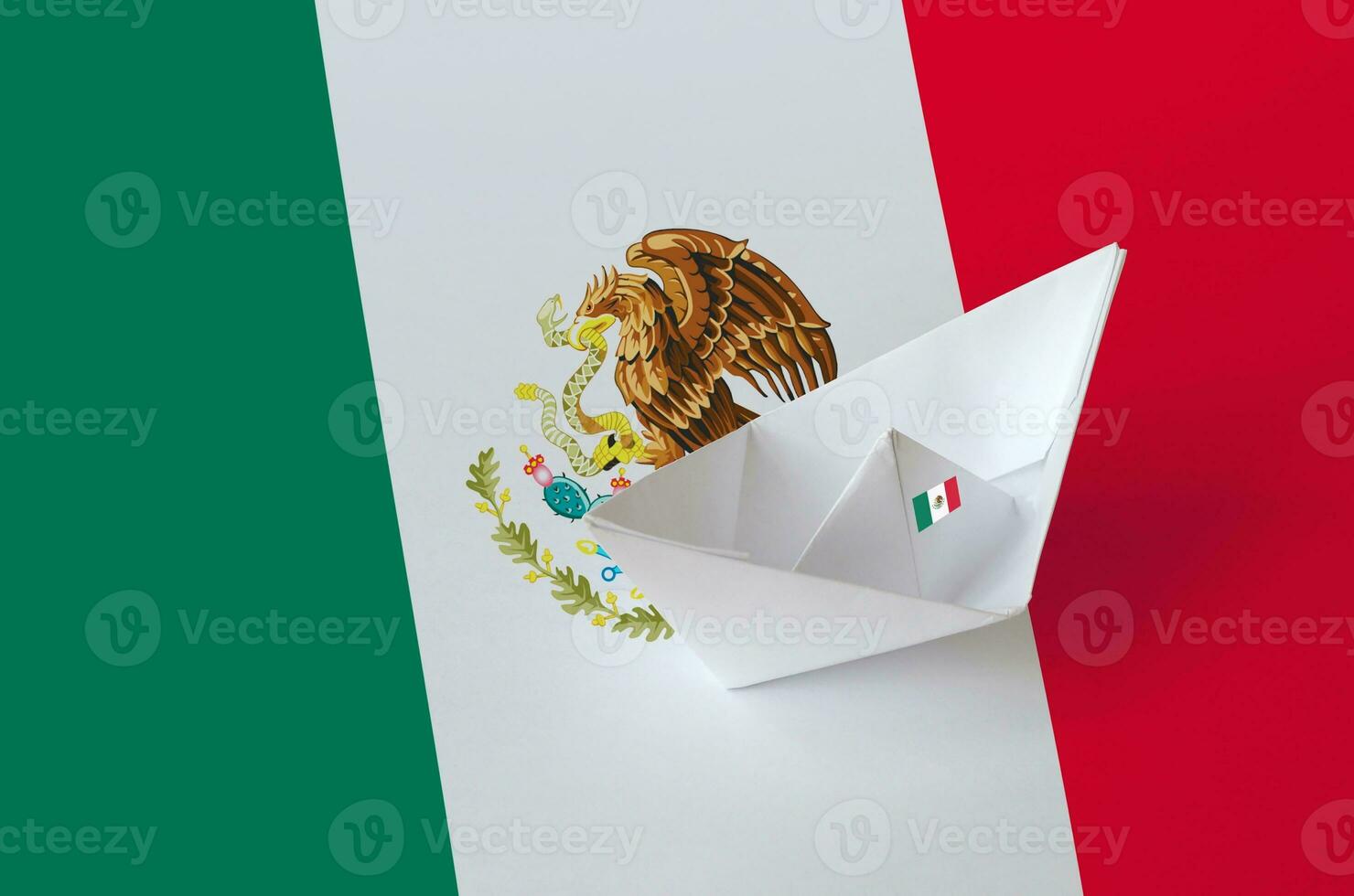 Mexico flag depicted on paper origami ship closeup. Handmade arts concept photo