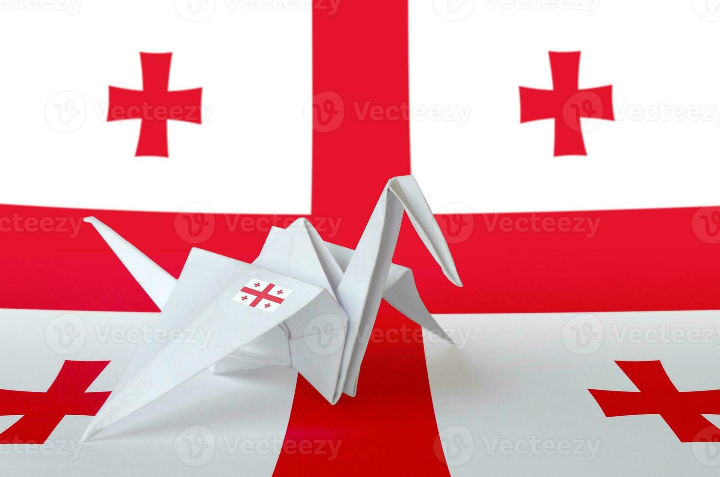 Georgia flag depicted on paper origami crane wing. Handmade arts concept photo