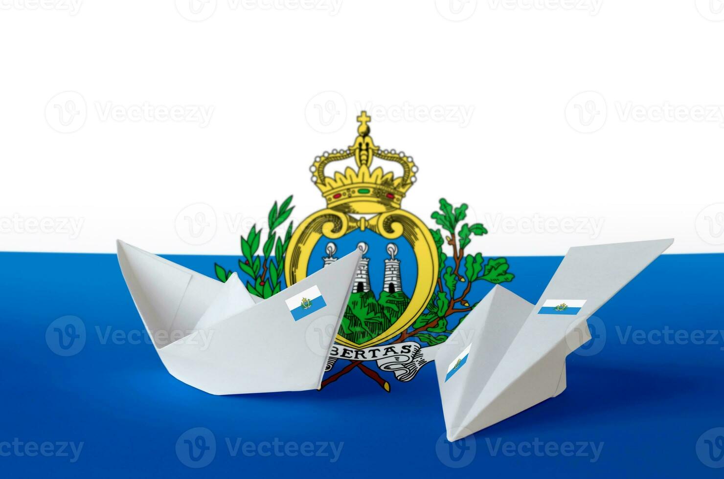 San Marino flag depicted on paper origami airplane and boat. Handmade arts concept photo