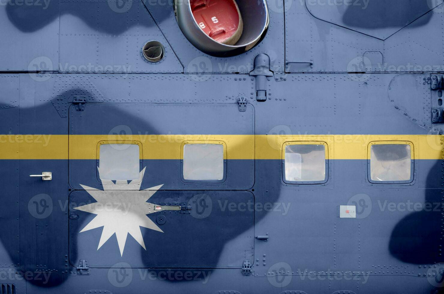 Nauru flag depicted on side part of military armored helicopter closeup. Army forces aircraft conceptual background photo