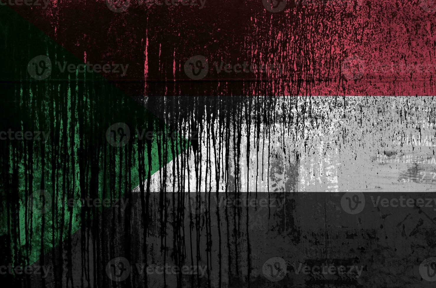 Sudan flag depicted in paint colors on old and dirty oil barrel wall closeup. Textured banner on rough background photo