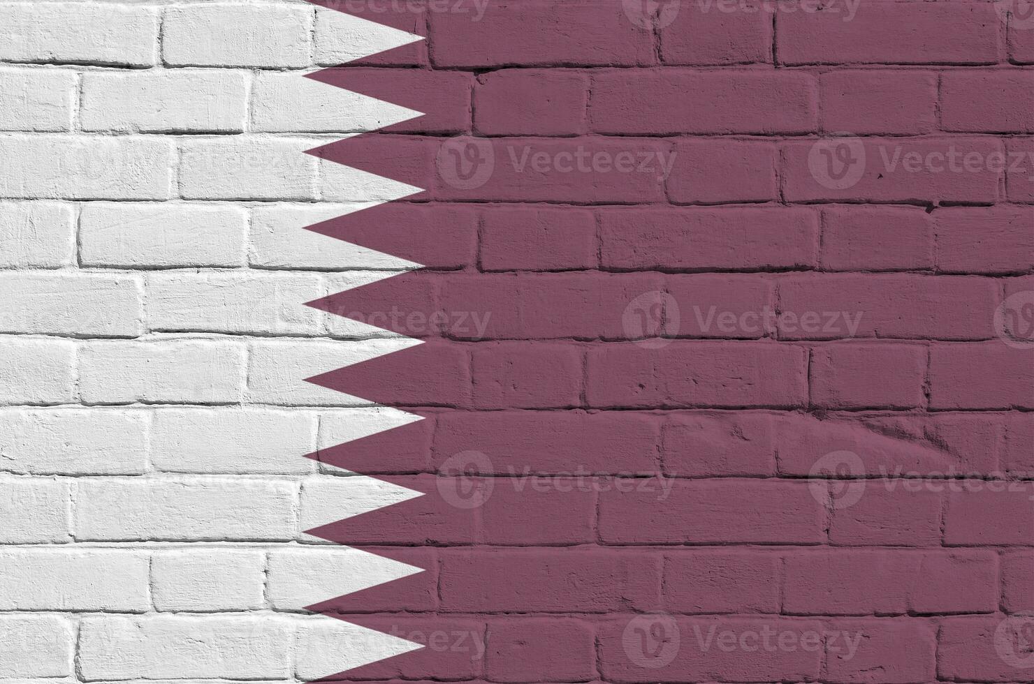 Qatar flag depicted in paint colors on old brick wall. Textured banner on big brick wall masonry background photo