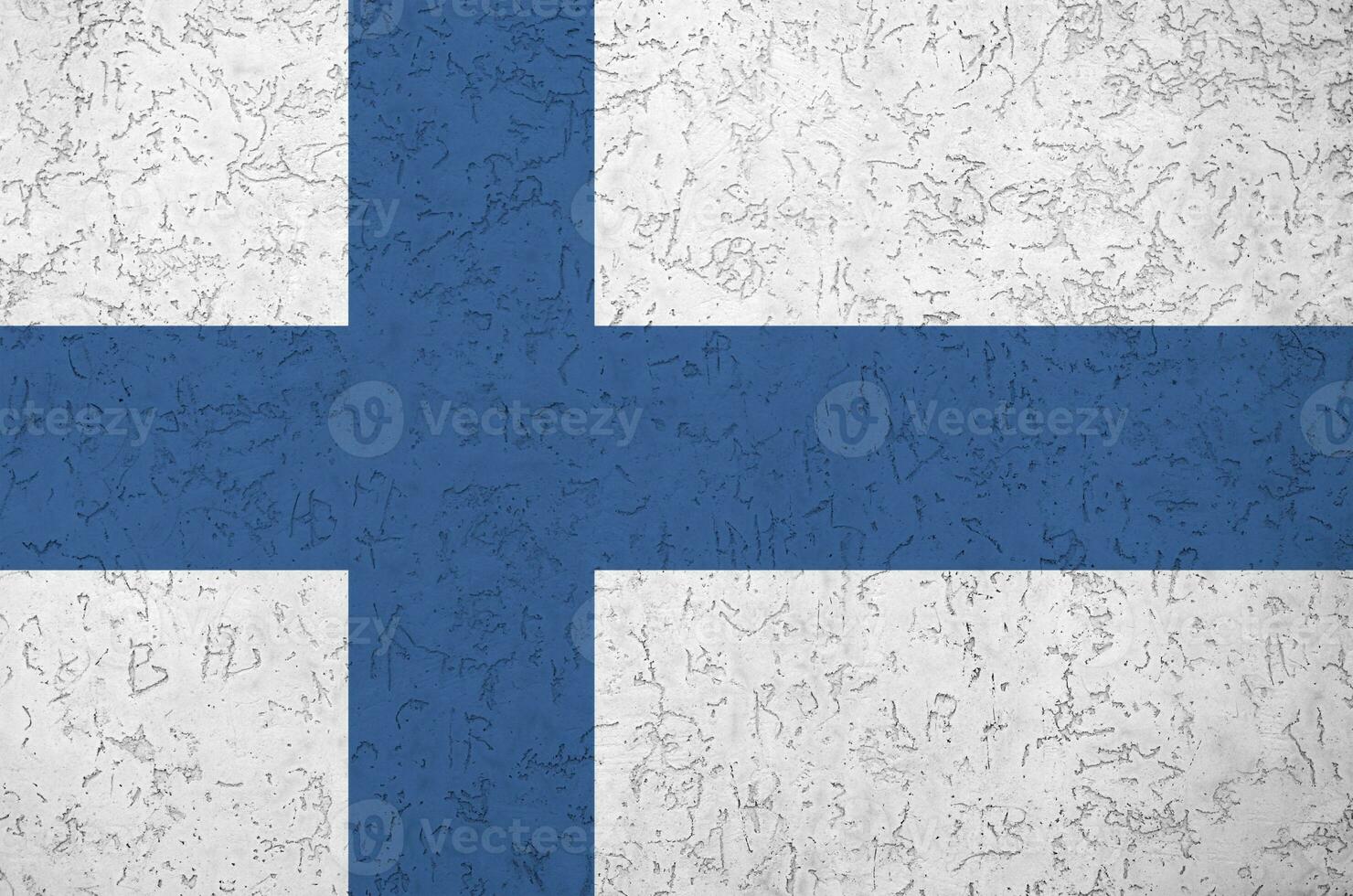 Finland flag depicted in bright paint colors on old relief plastering wall. Textured banner on rough background photo