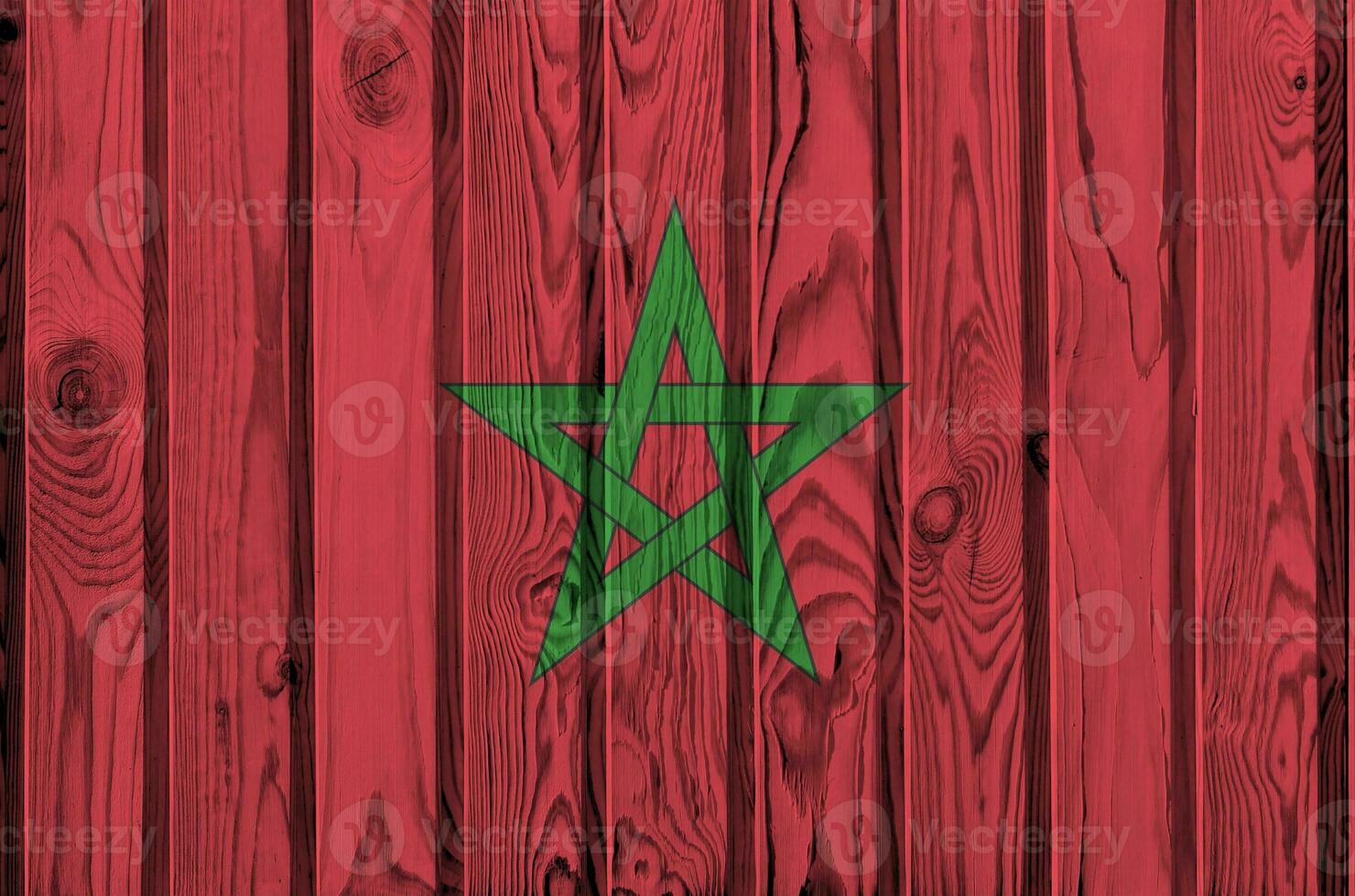 Morocco flag depicted in bright paint colors on old wooden wall. Textured banner on rough background photo