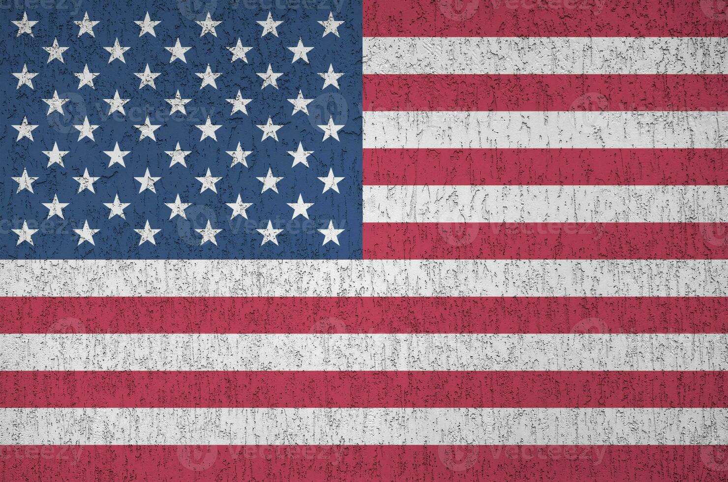 United States of America flag depicted in bright paint colors on old relief plastering wall. Textured banner on rough background photo