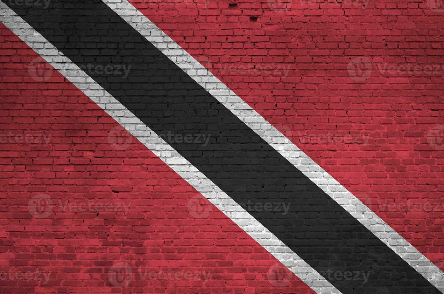 Trinidad and Tobago flag depicted in paint colors on old brick wall. Textured banner on big brick wall masonry background photo
