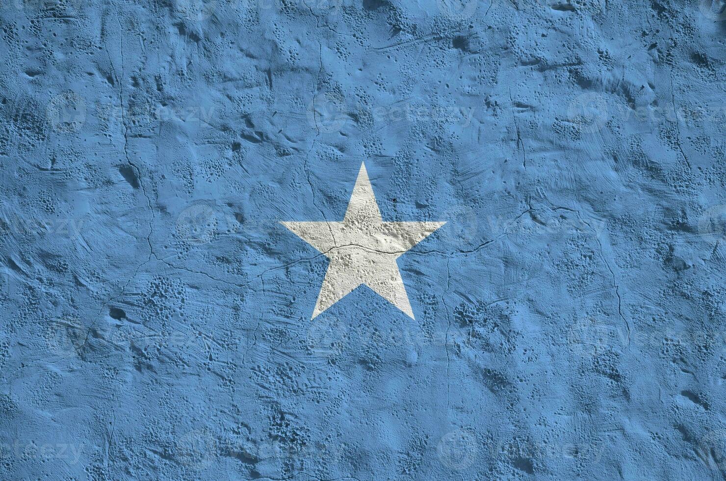 Somalia flag depicted in bright paint colors on old relief plastering wall. Textured banner on rough background photo