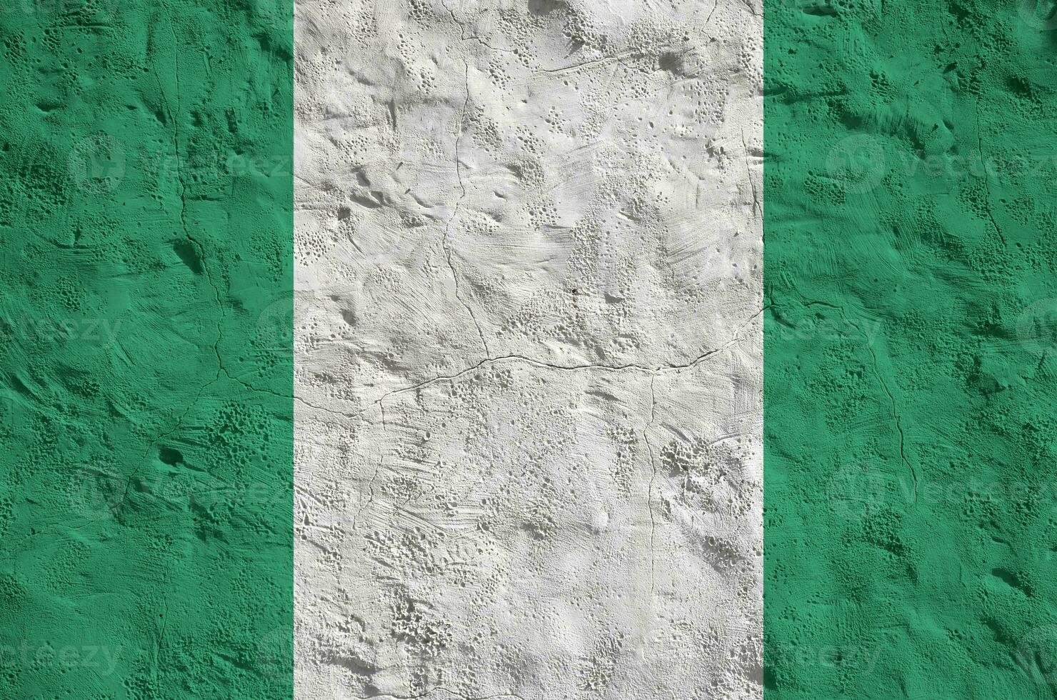 Nigeria flag depicted in bright paint colors on old relief plastering wall. Textured banner on rough background photo