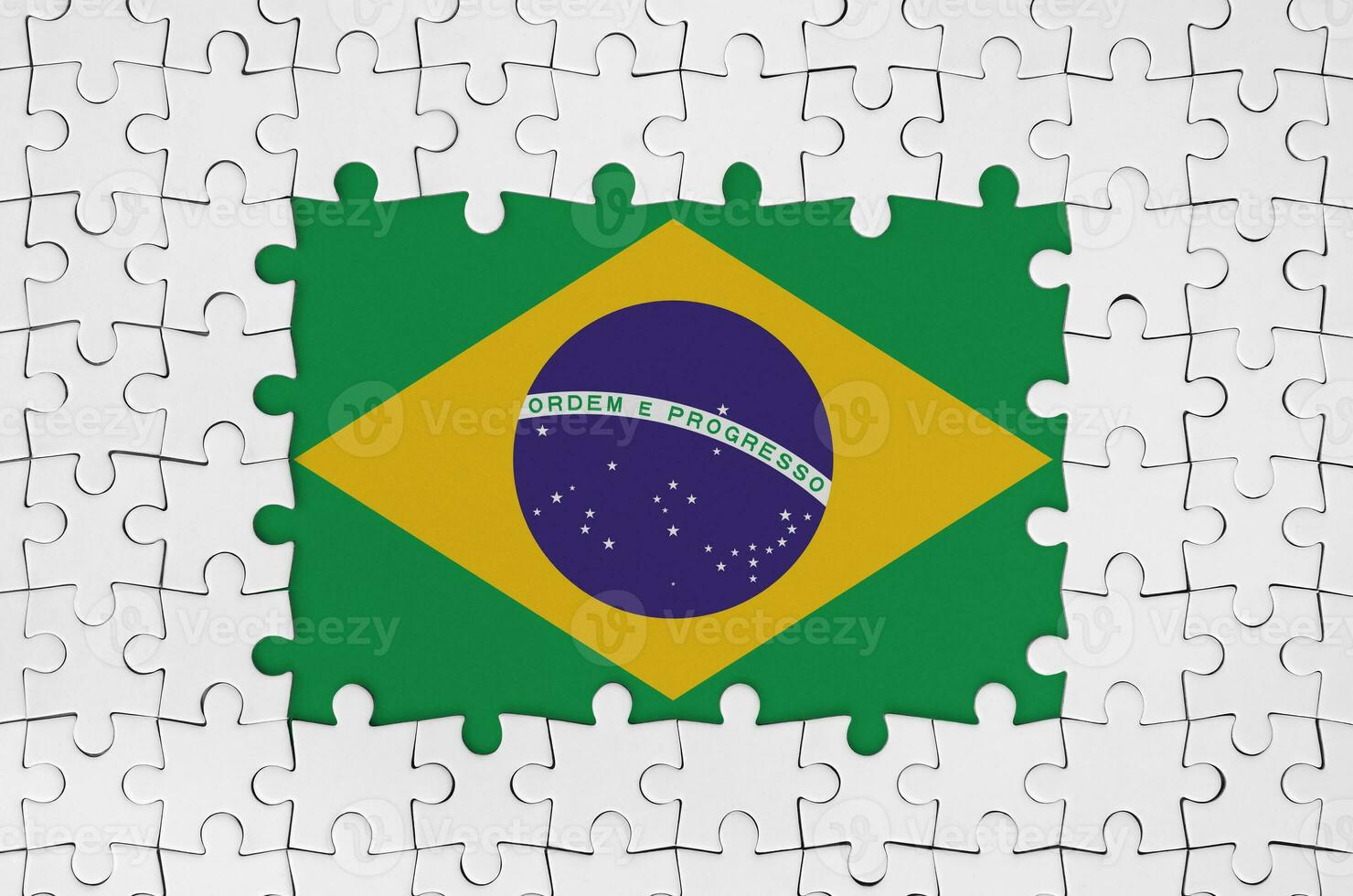 Brazil flag in frame of white puzzle pieces with missing central part photo