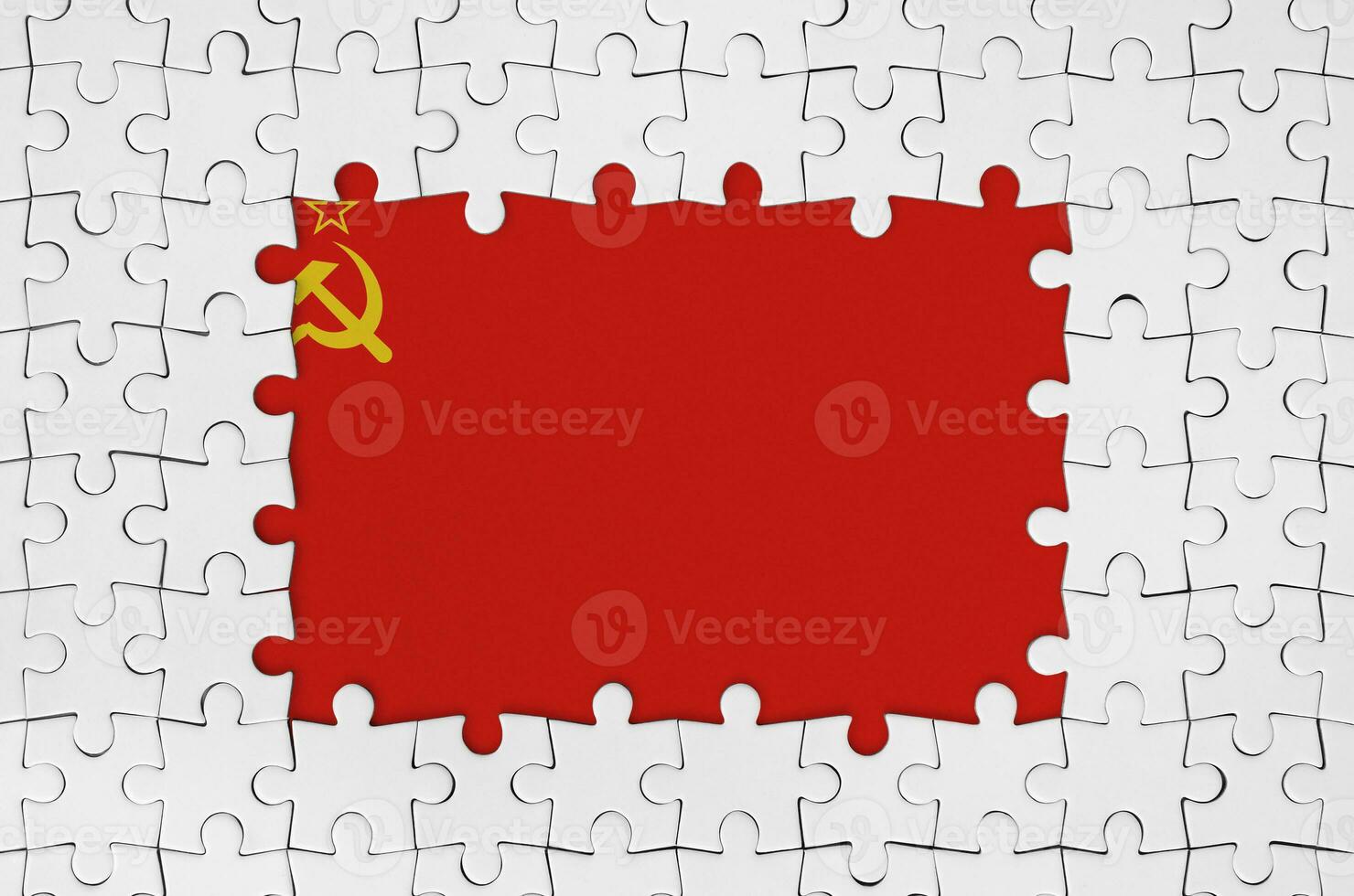 Soviet Union flag in frame of white puzzle pieces with missing central part photo