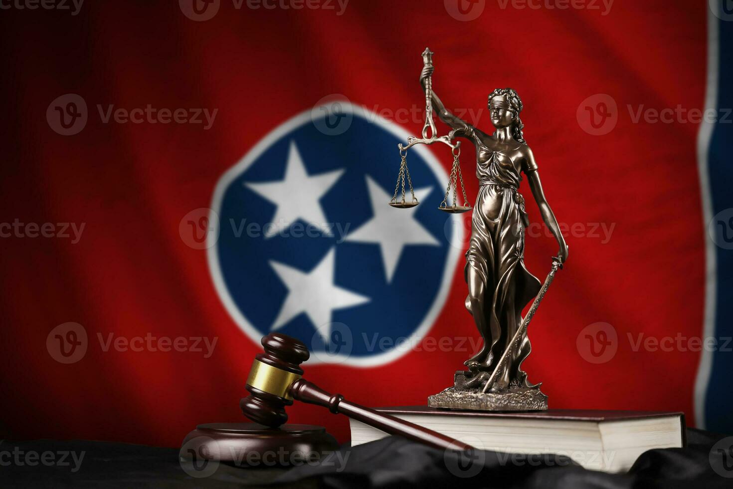 Tennessee US state flag with statue of lady justice, constitution and judge hammer on black drapery. Concept of judgement and guilt photo