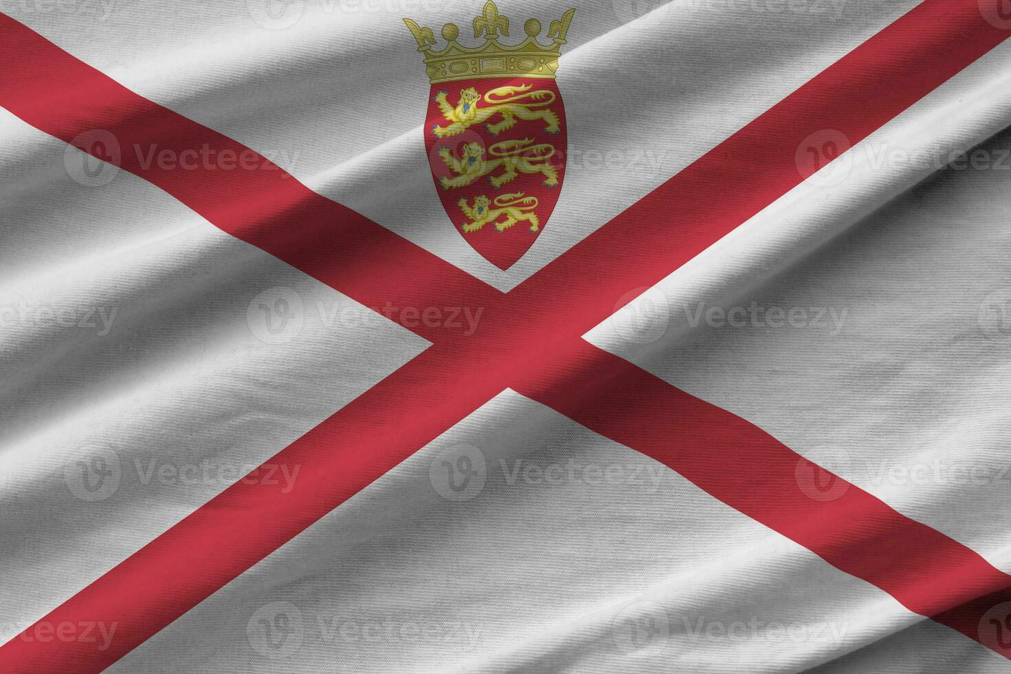 Jersey flag with big folds waving close up under the studio light indoors. The official symbols and colors in banner photo