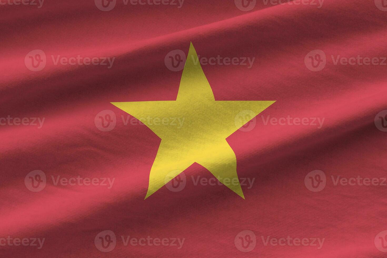 Vietnam flag with big folds waving close up under the studio light indoors. The official symbols and colors in banner photo