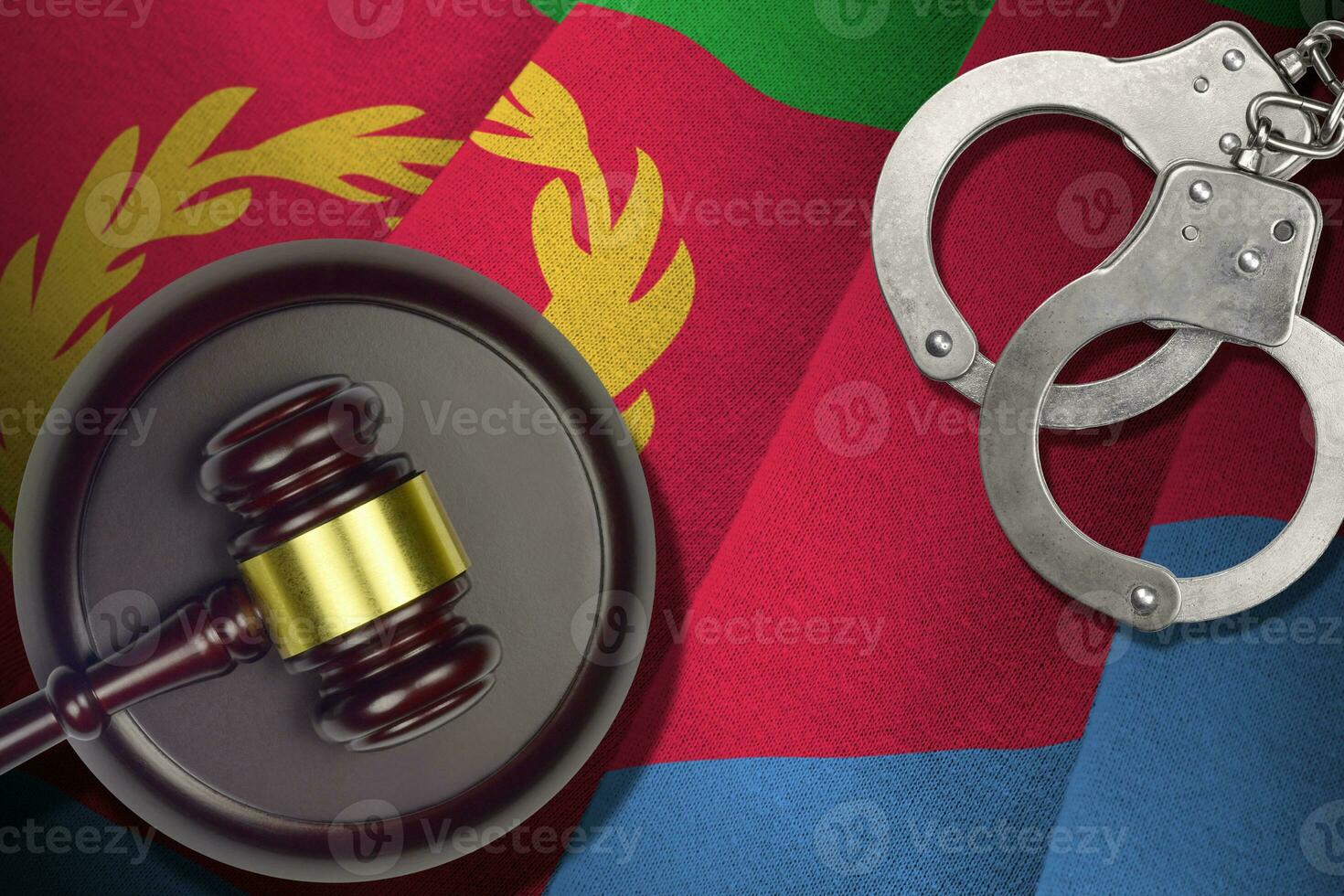 Eritrea flag with judge mallet and handcuffs in dark room. Concept of criminal and punishment, background for judgement topics photo