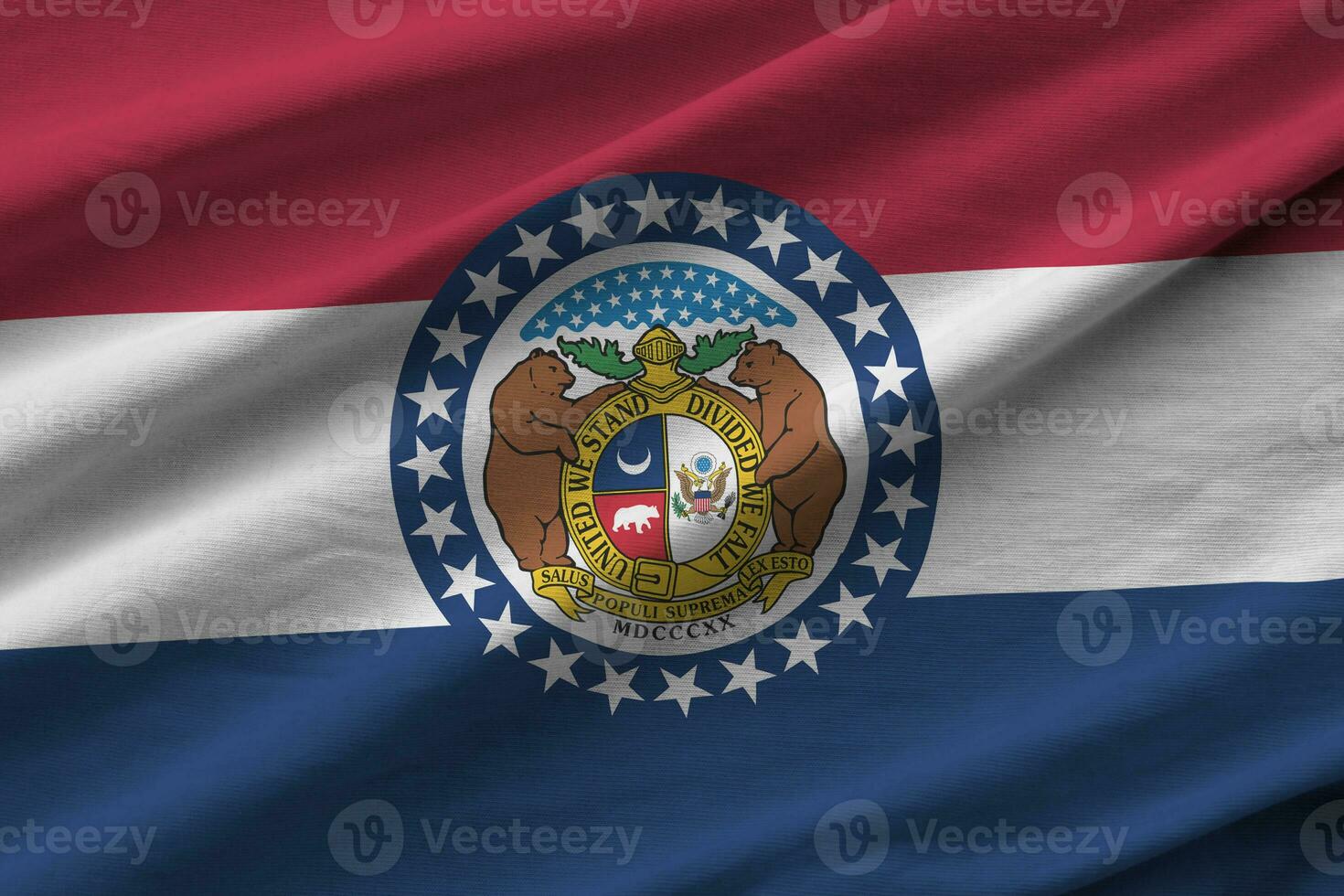 Missouri US state flag with big folds waving close up under the studio light indoors. The official symbols and colors in banner photo