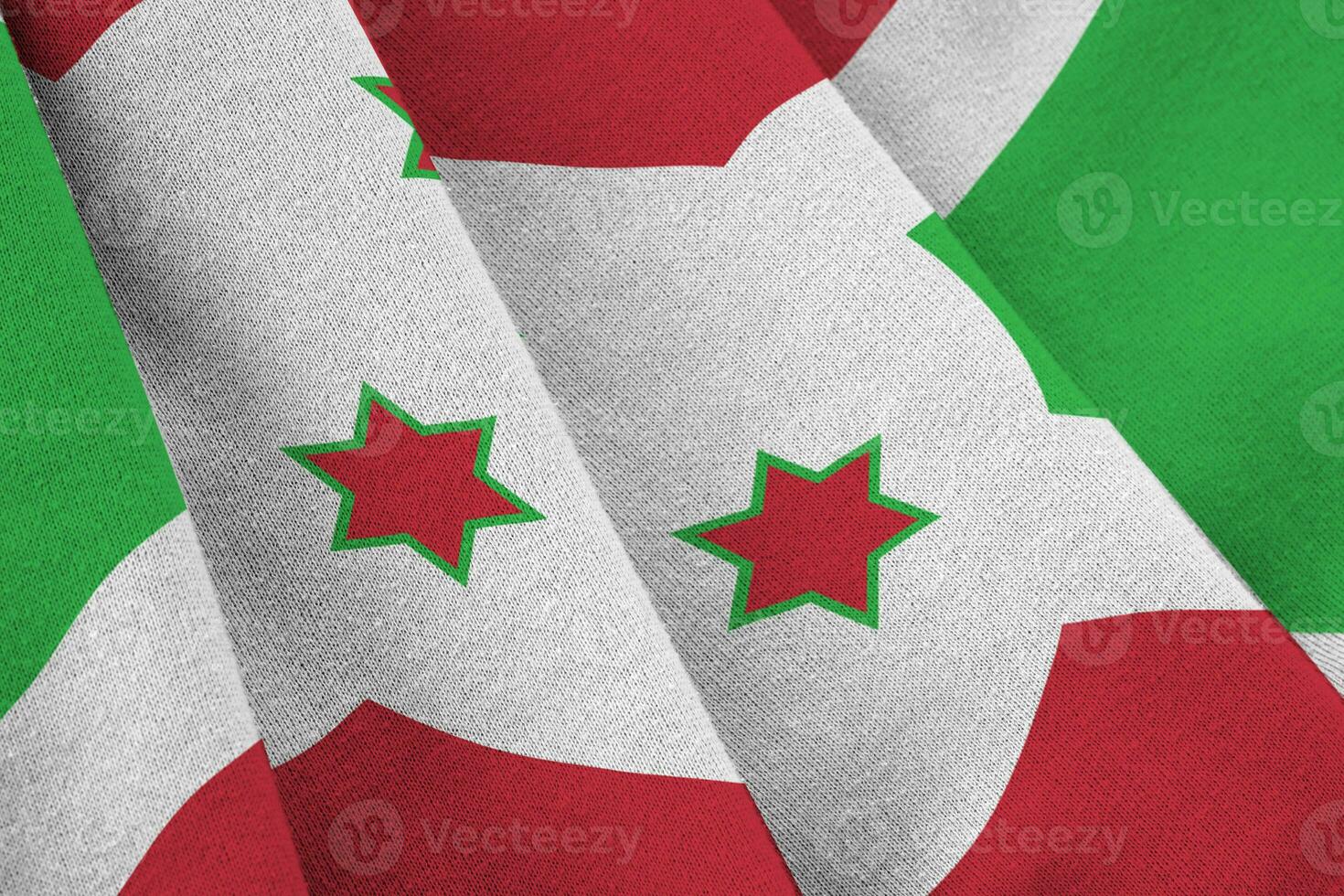 Burundi flag with big folds waving close up under the studio light indoors. The official symbols and colors in banner photo