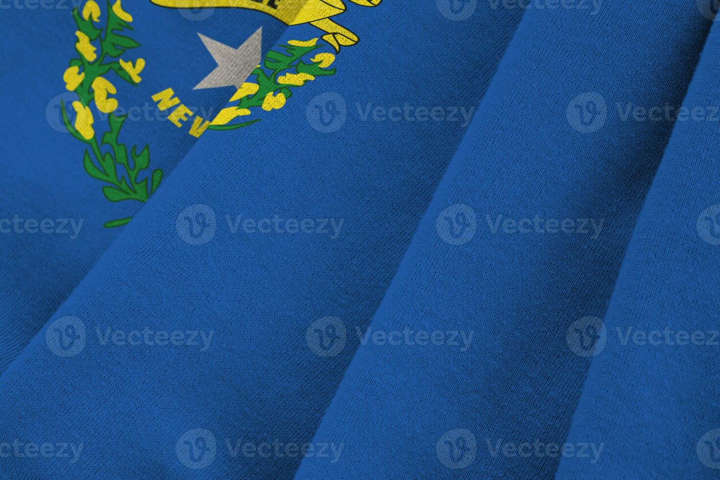 Nevada US state flag with big folds waving close up under the studio light indoors. The official symbols and colors in banner photo