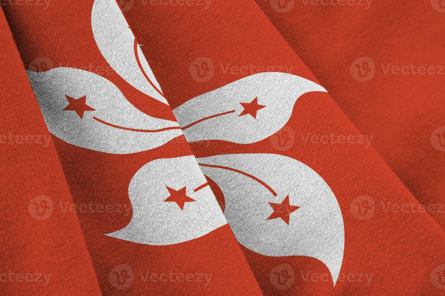 Hong kong flag with big folds waving close up under the studio light indoors. The official symbols and colors in banner photo