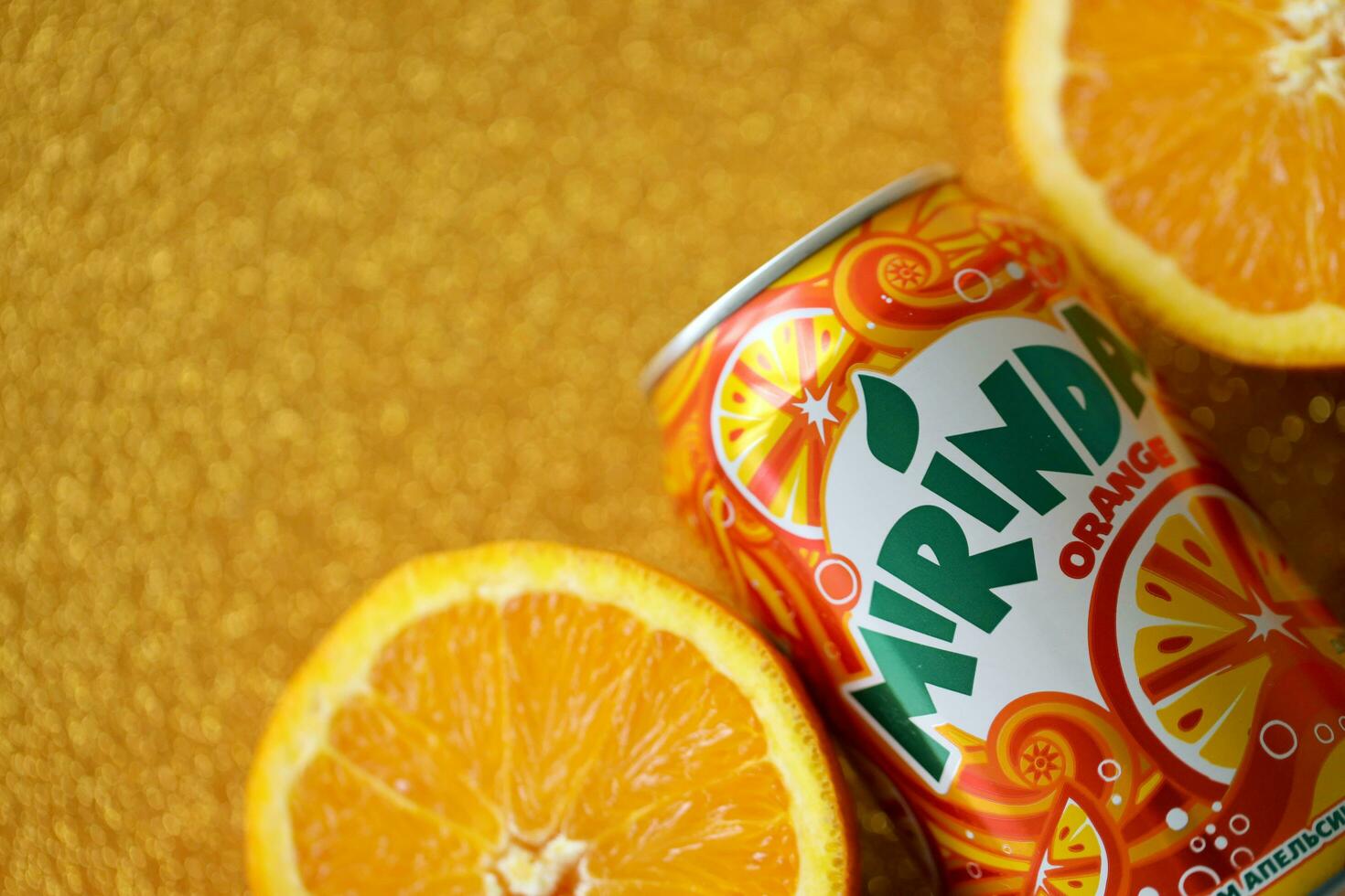 KYIV, UKRAINE - JULY 7, 2023 Mirinda orange drink with many oranges on colorful background photo
