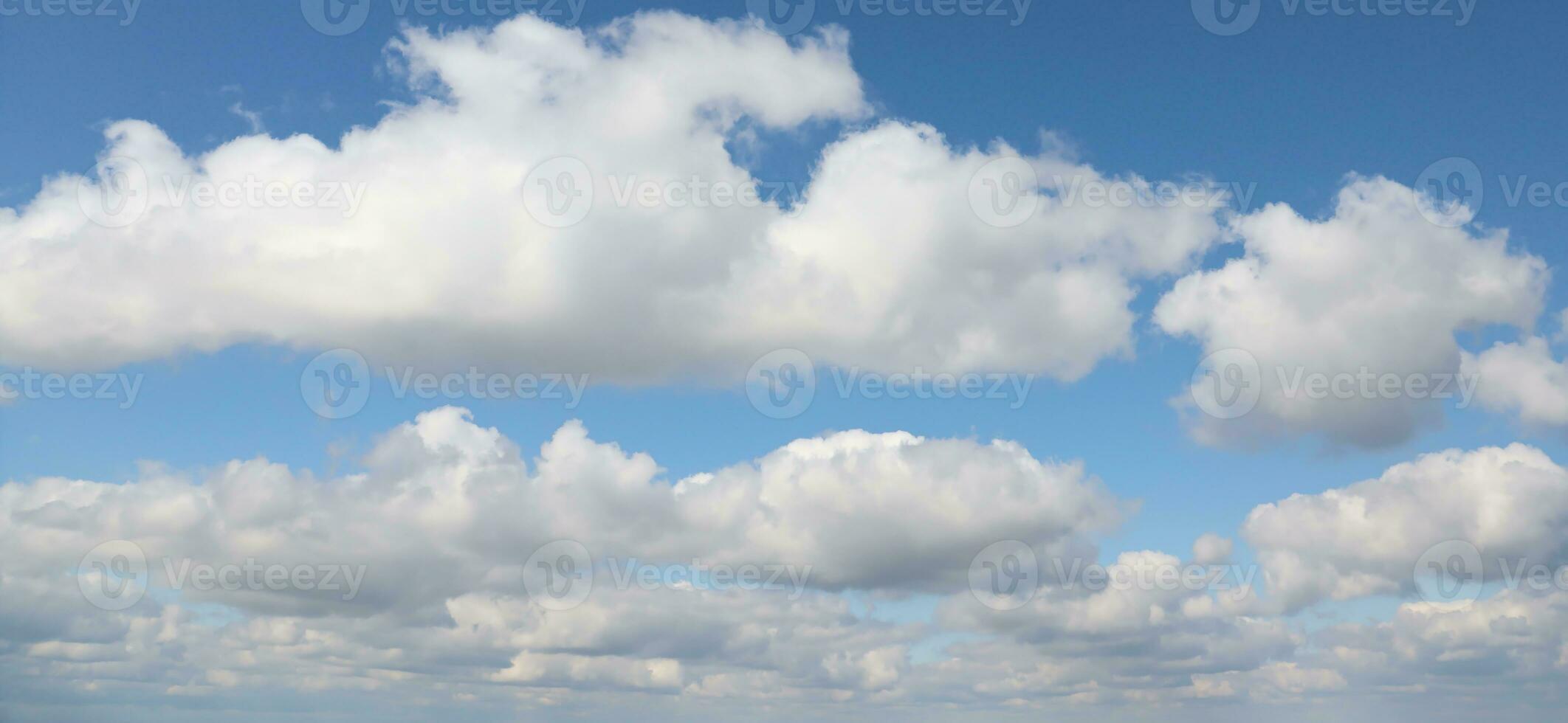 Blue sky background with white fluffy clouds in daytime outdoors photo