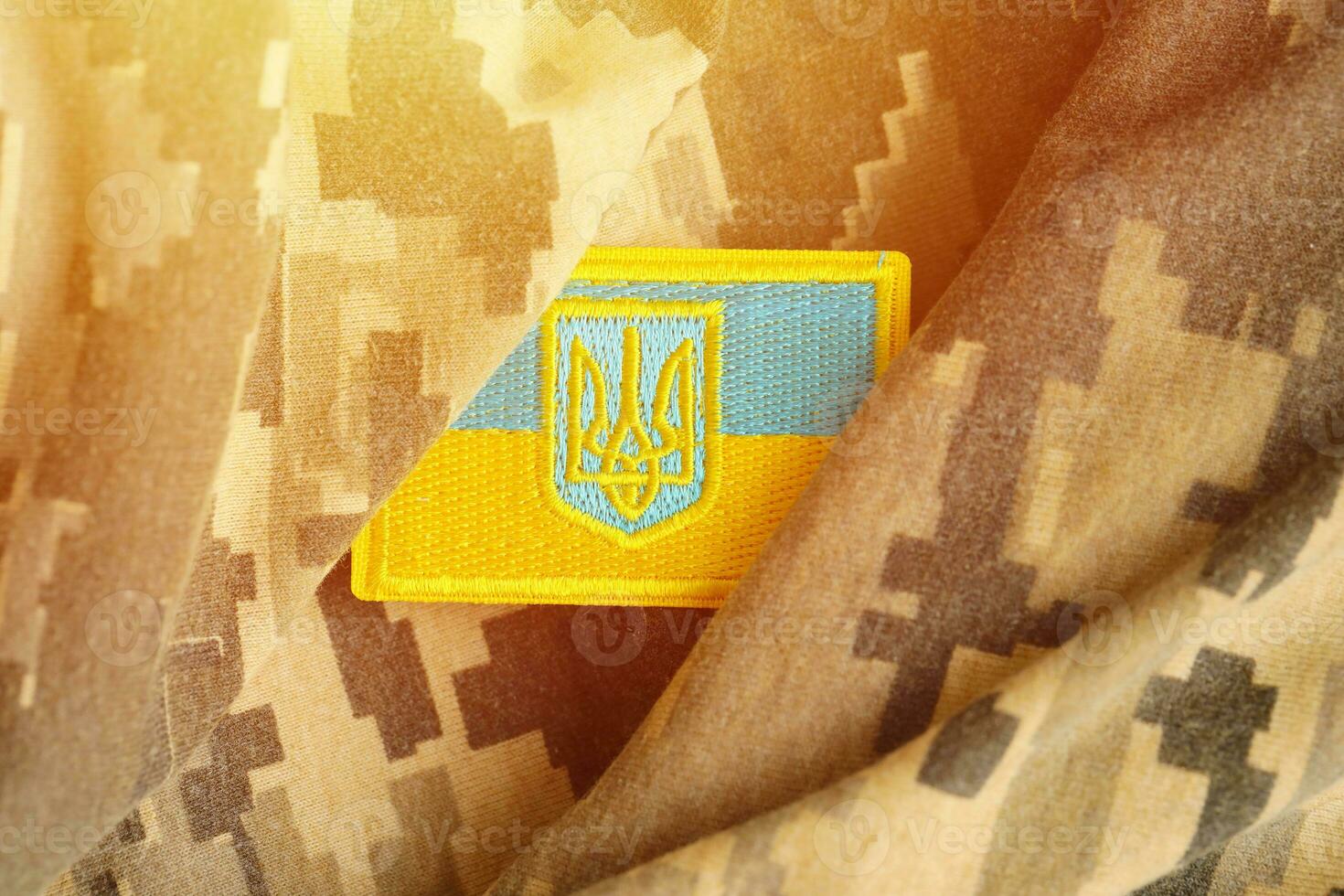 Military camouflage fabric with ukrainian flag on uniform chevron photo